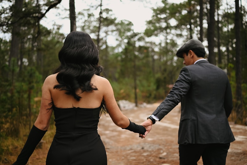 Romantic couple walking through scenic forest path