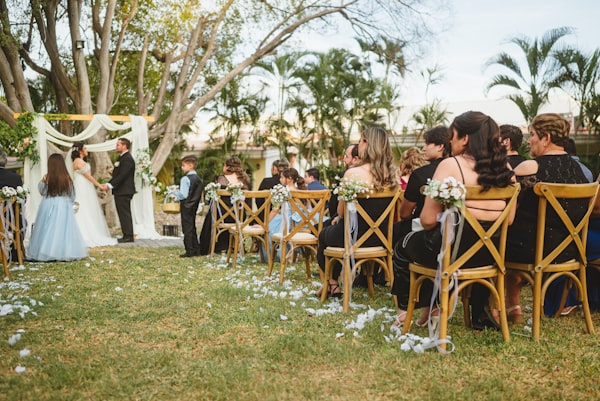 Close-up of hands with delicate pink flowers during design phase