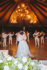 Couple dances as mariachi band plays at wedding reception
