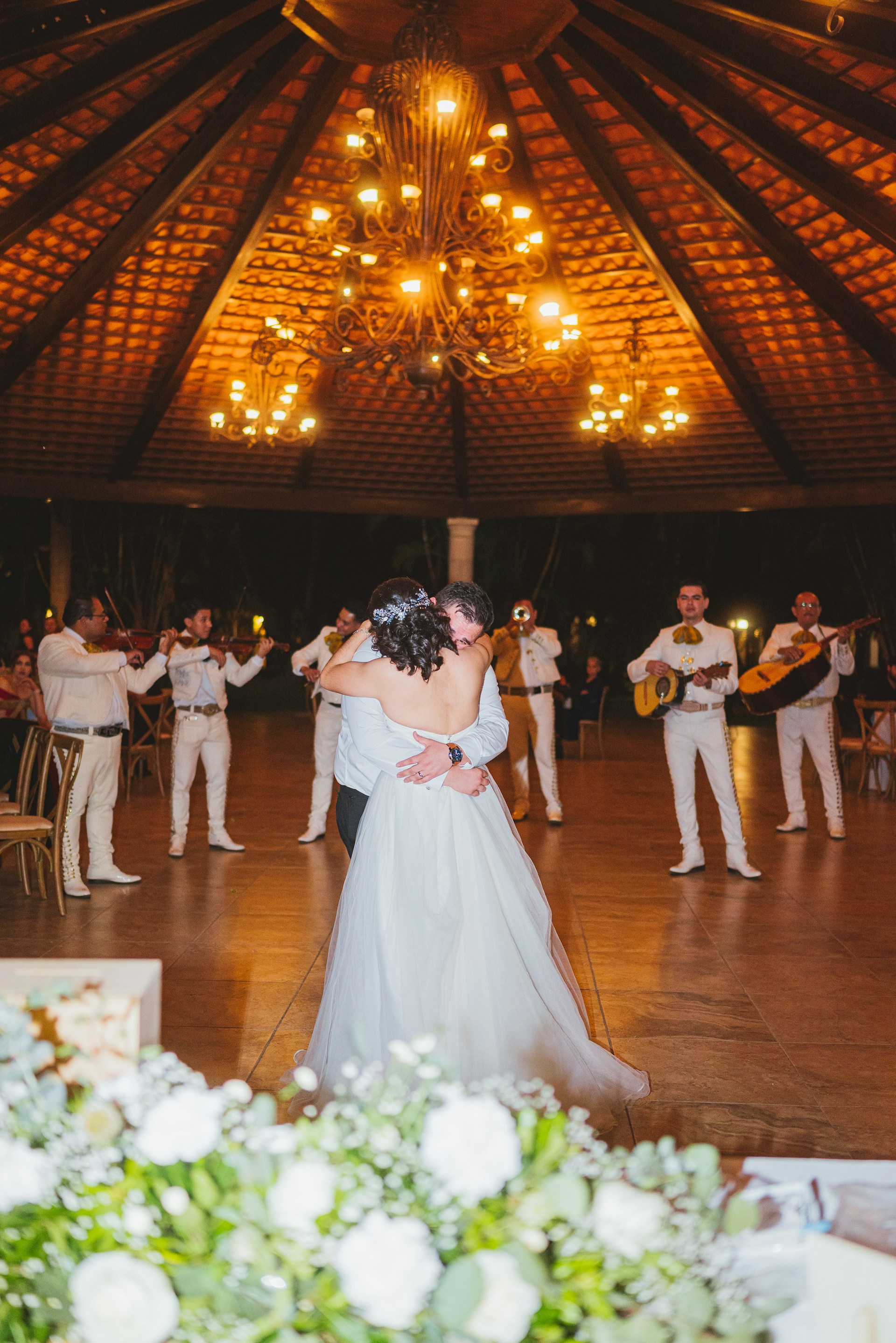 Couple dances as mariachi band plays at wedding reception