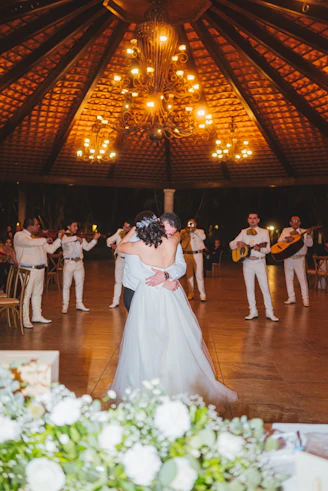 Couple dances as mariachi band plays at wedding reception