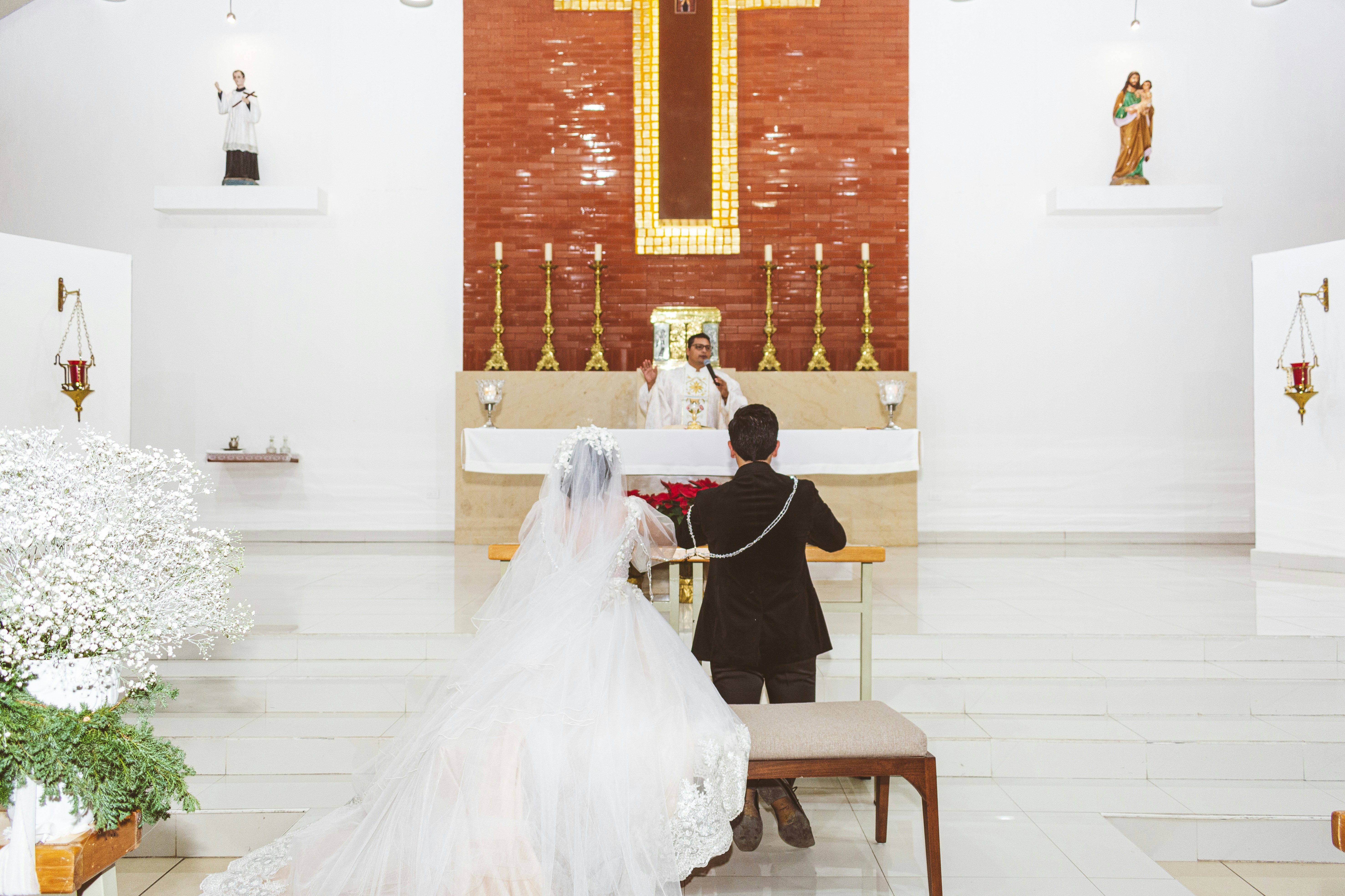 Wedding ceremony in a church with a priest.
