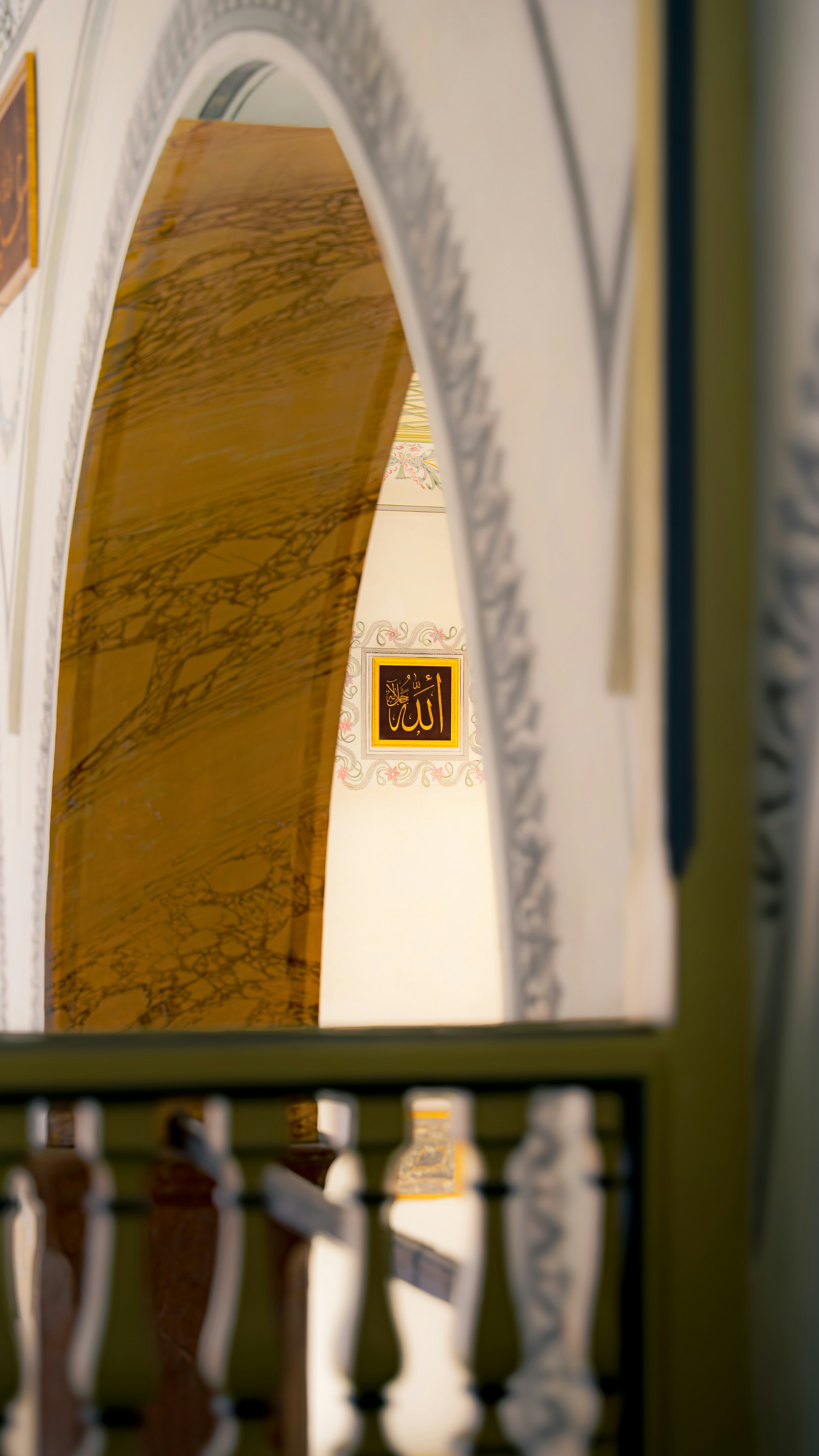 Islamic calligraphy adorns a mosque interior