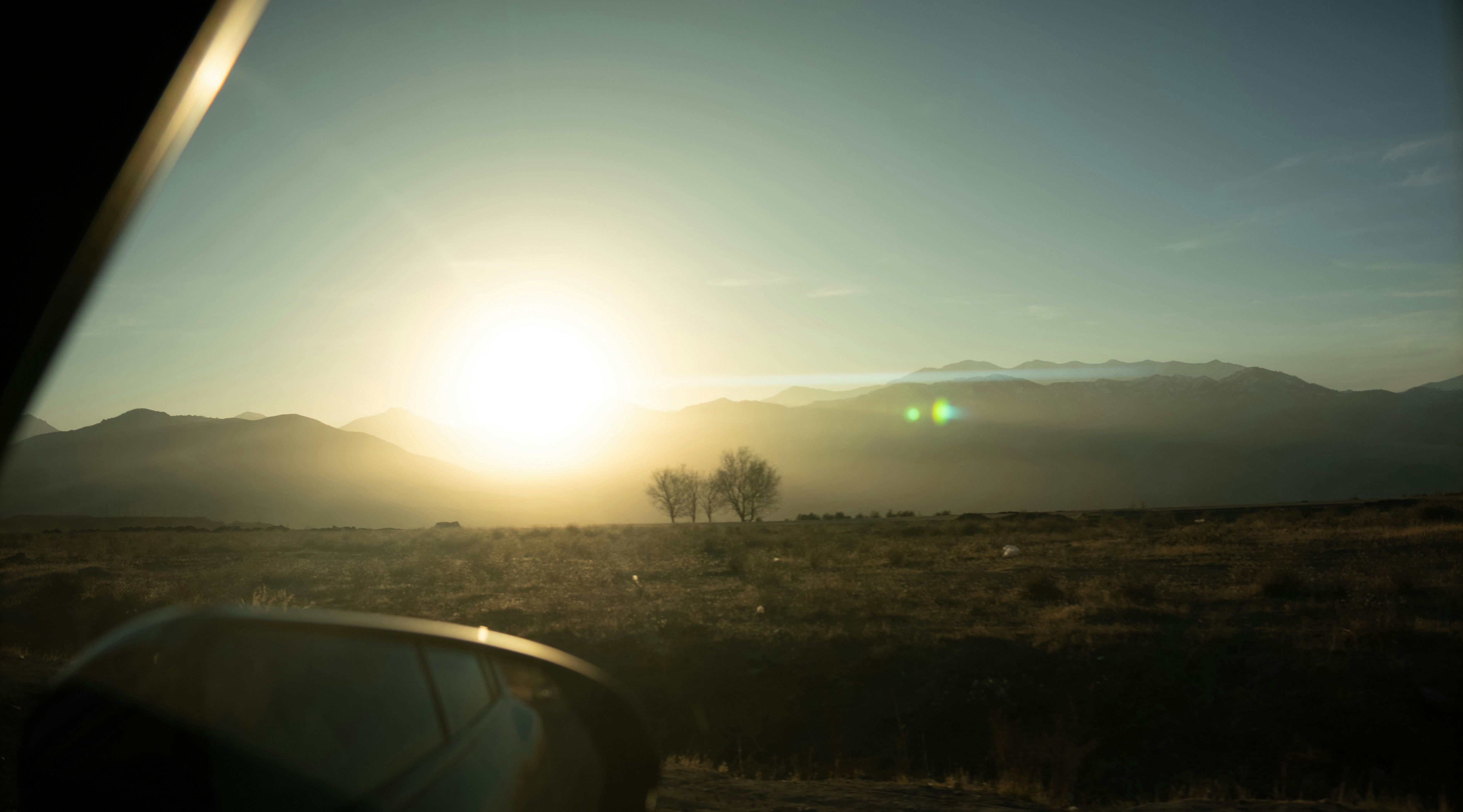 Sunrise over a misty mountain landscape.