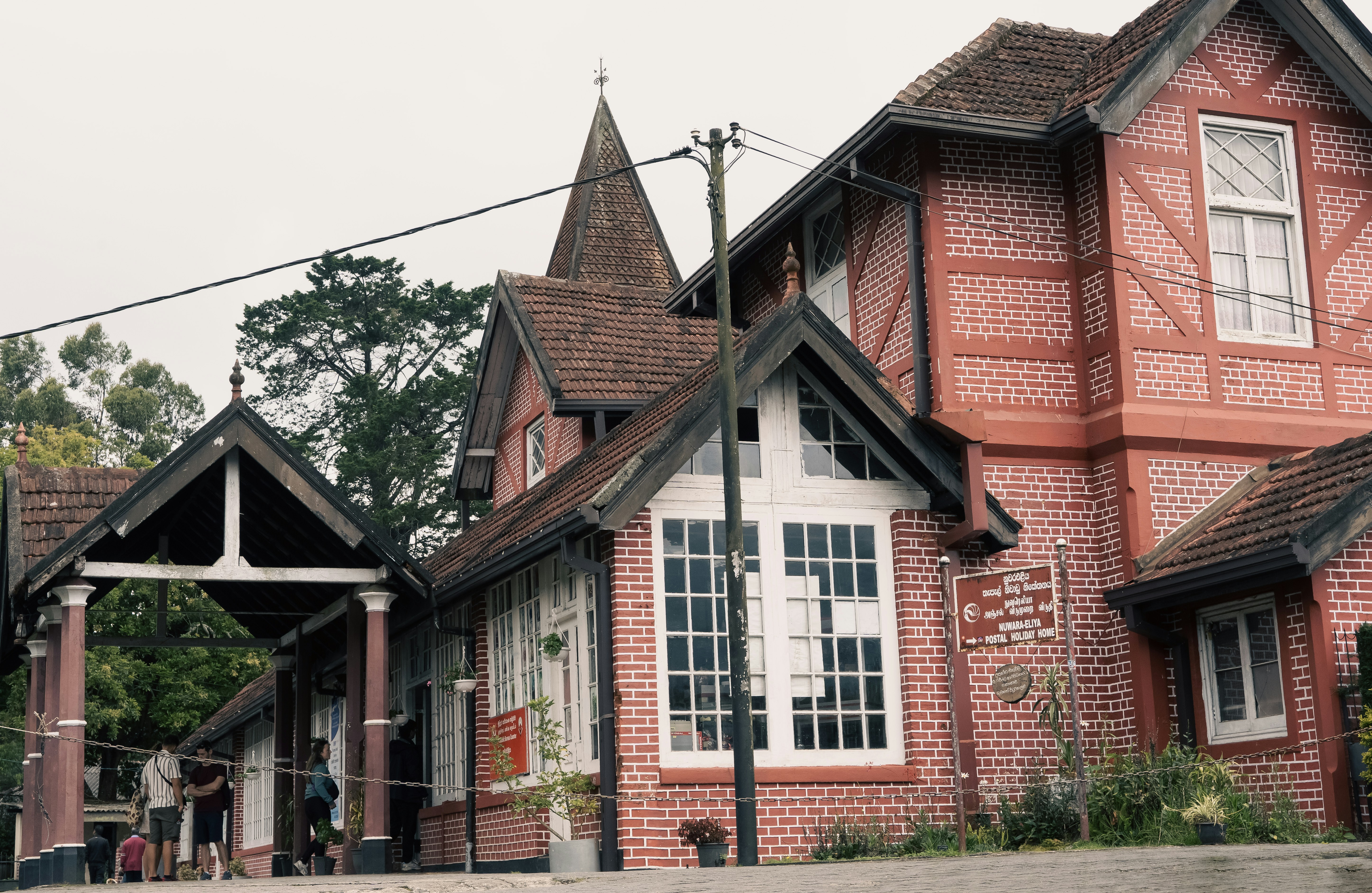Historic red brick building with white trim and gables.