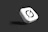 White cube with black symbol on dark background