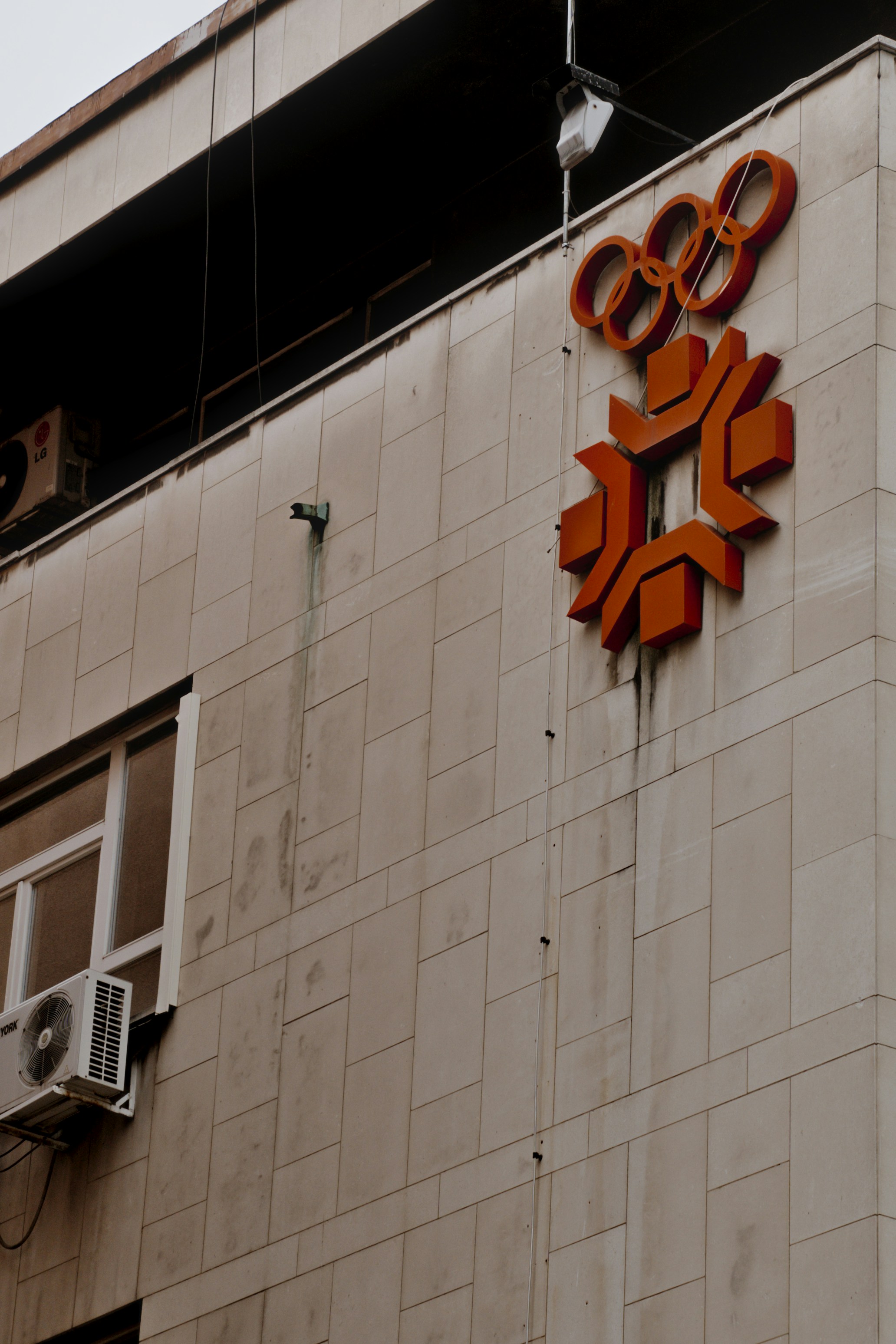 Building facade with olympic rings and emblem