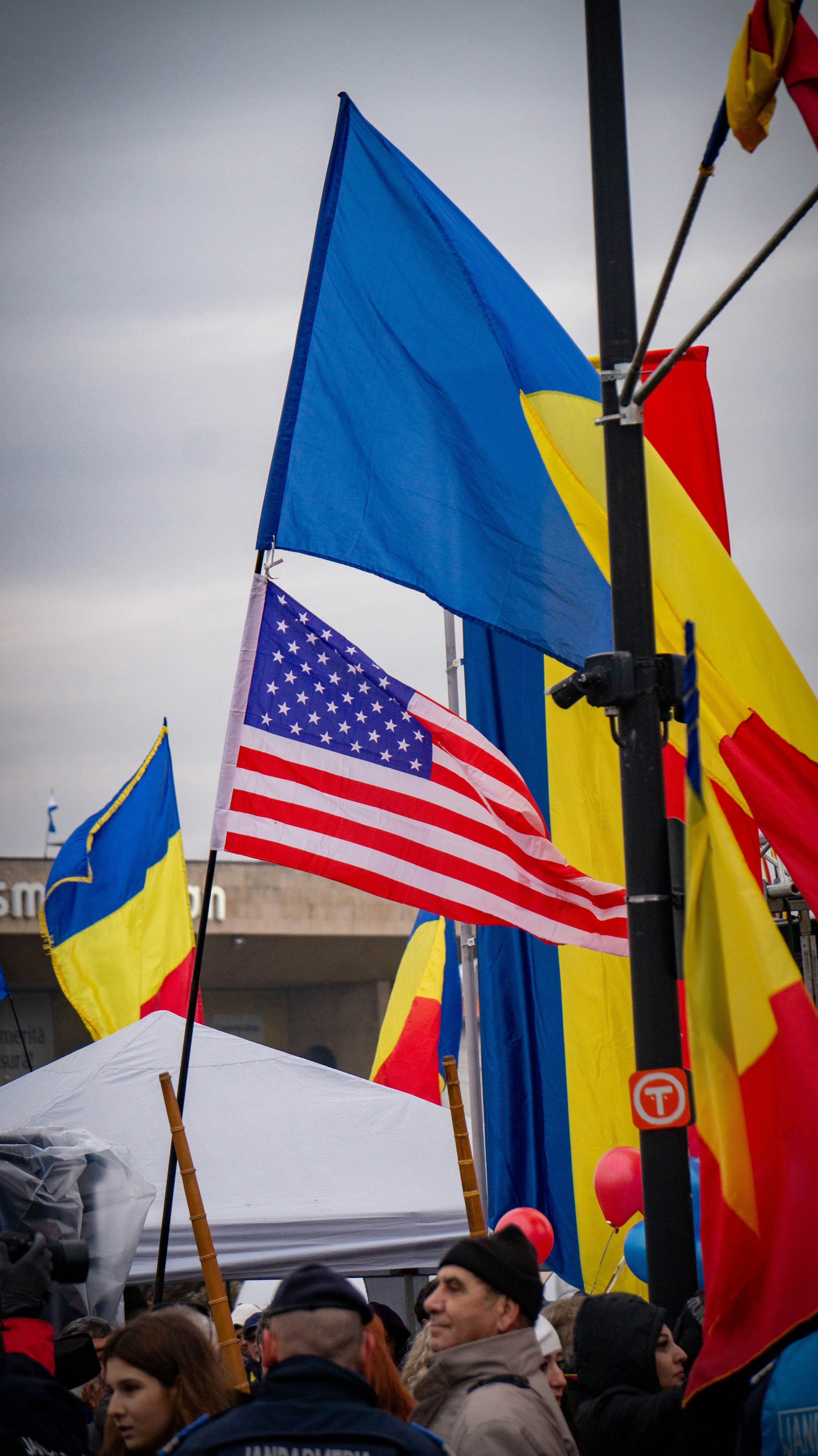 American and romanian flags wave in the wind.
