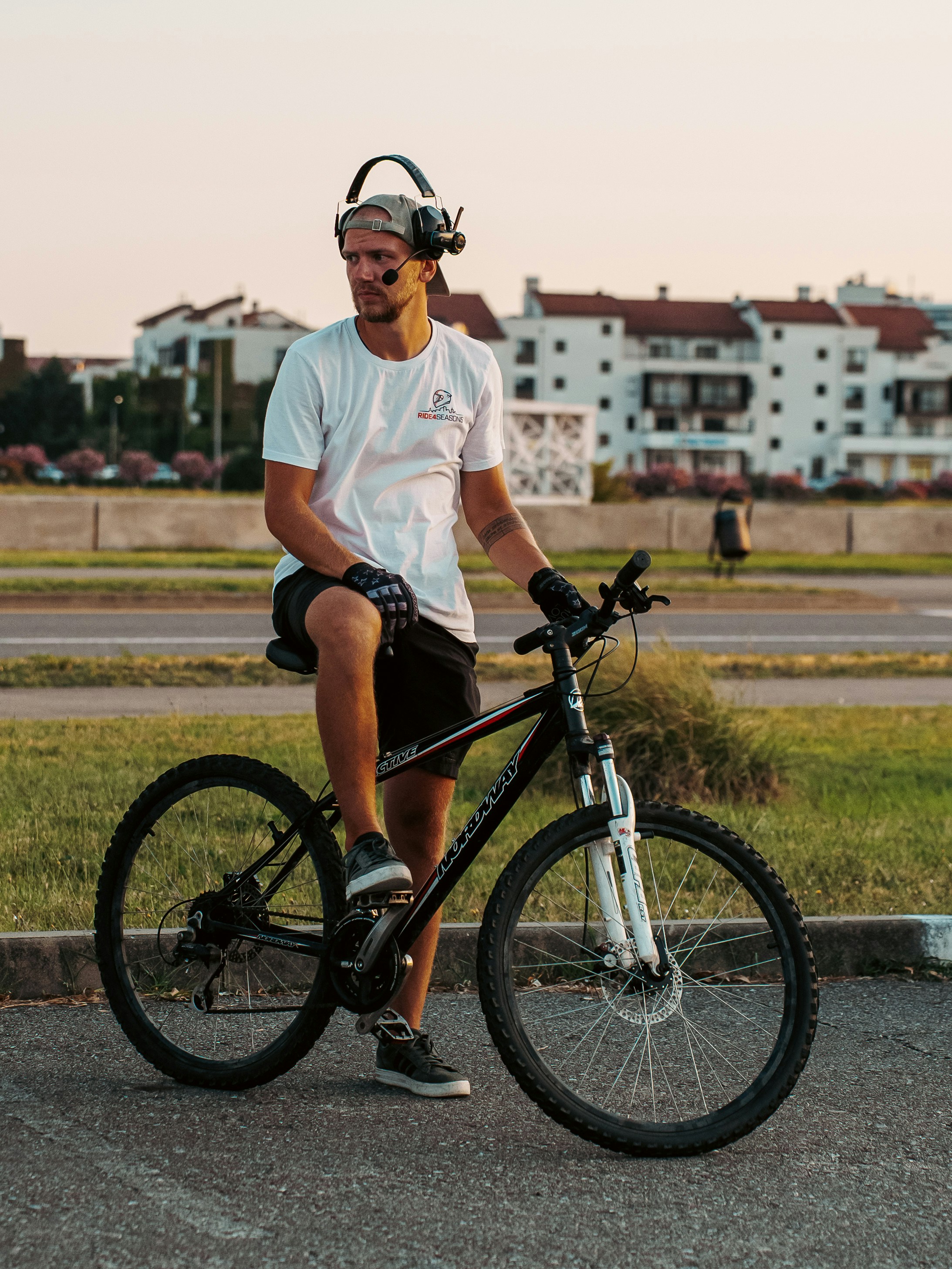 Man with headphones and bicycle in urban setting