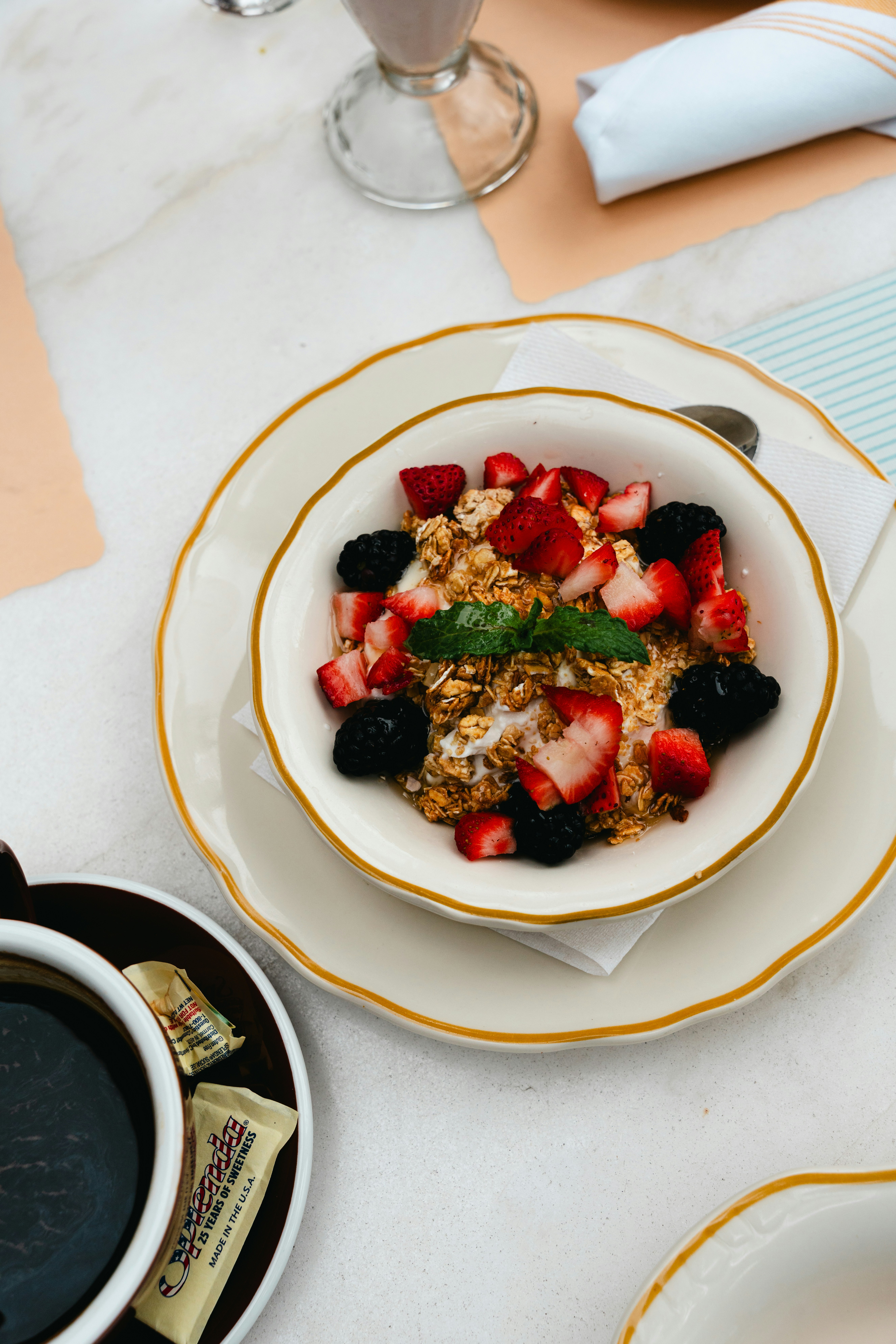 Bowl of granola with fresh berries and mint