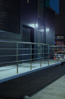 Modern building exterior with elevators and railing
