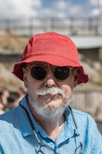 Man with red hat and sunglasses