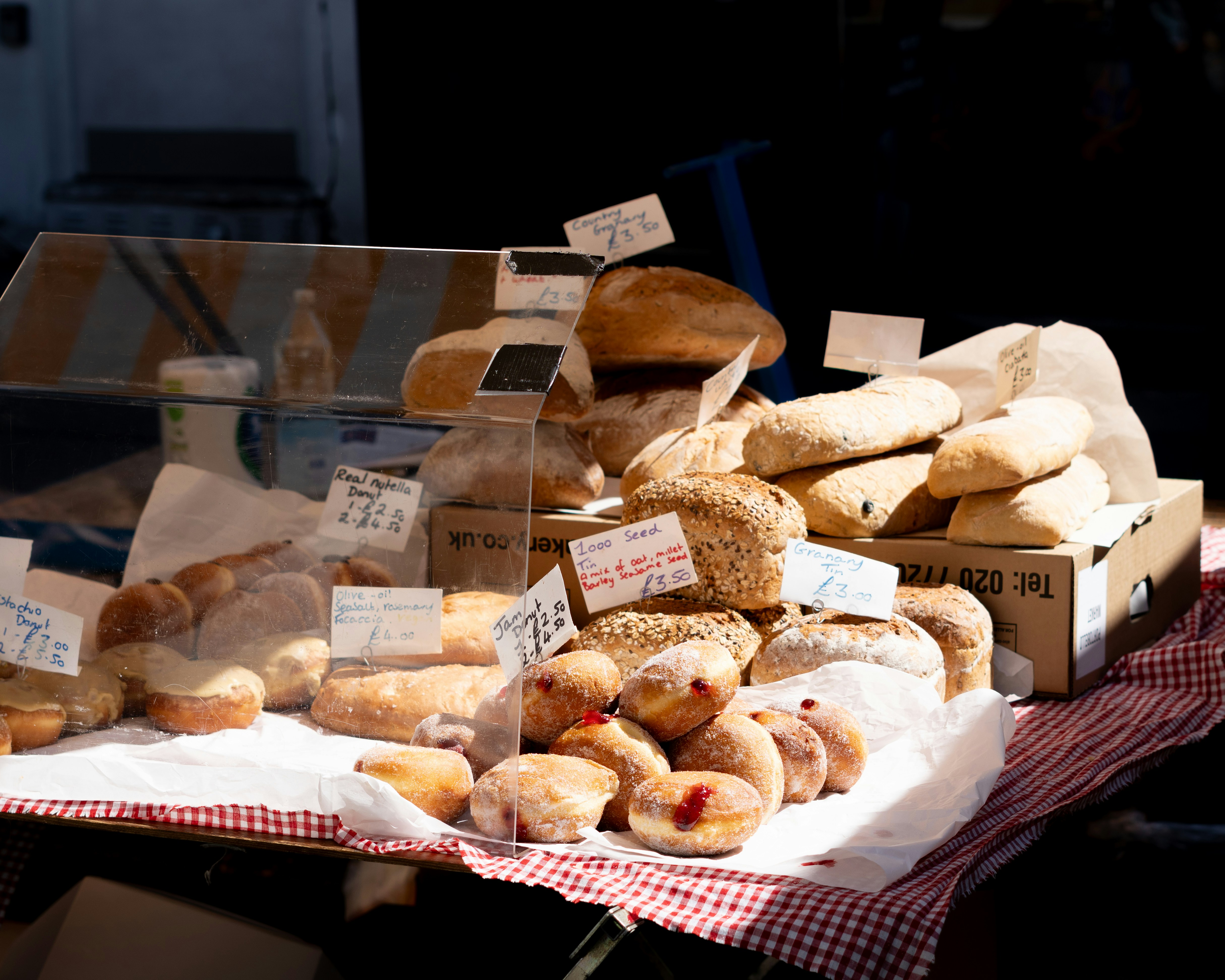 Assortment of fresh baked bread and pastries at market.