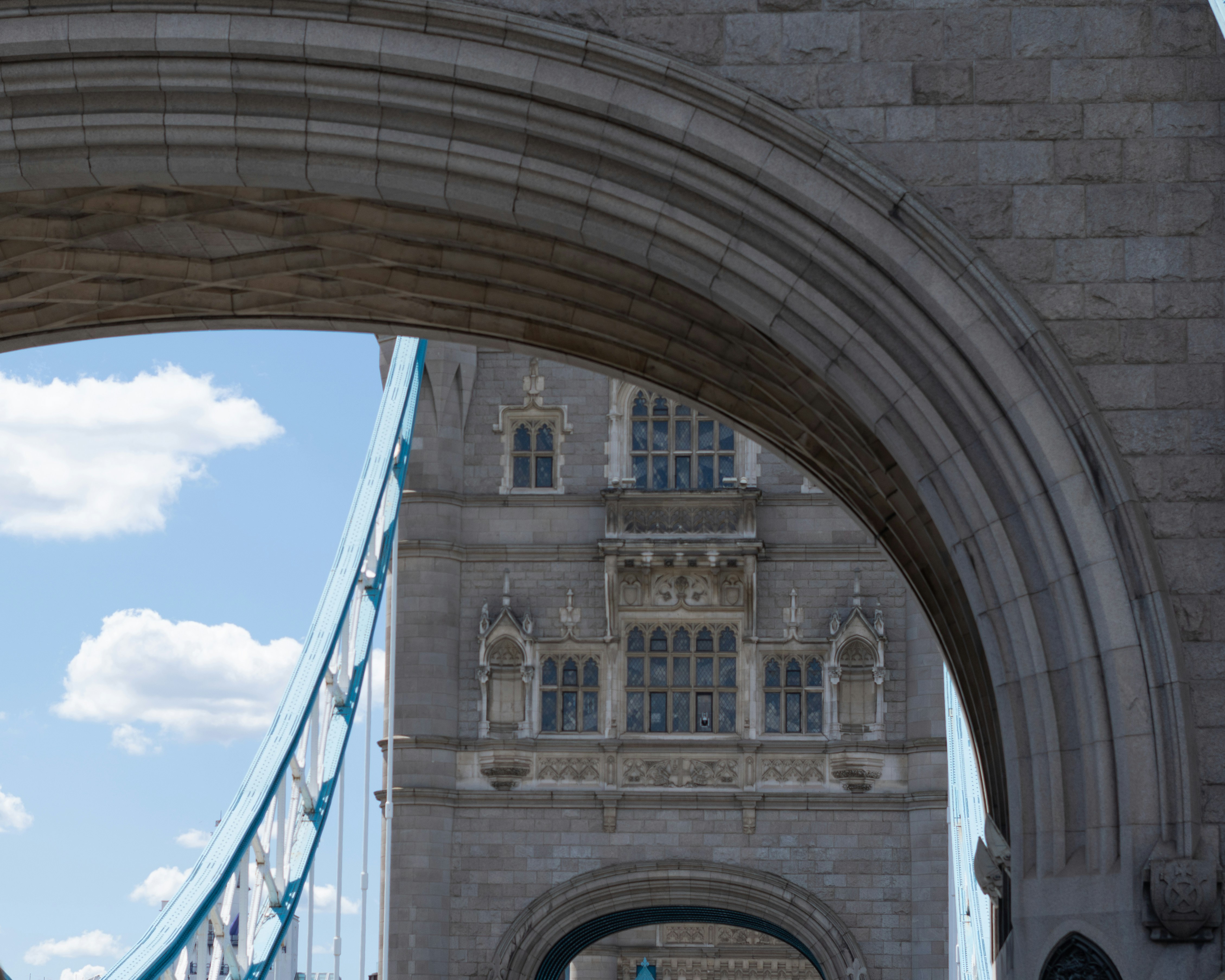 Stone archway framing a view of tower bridge