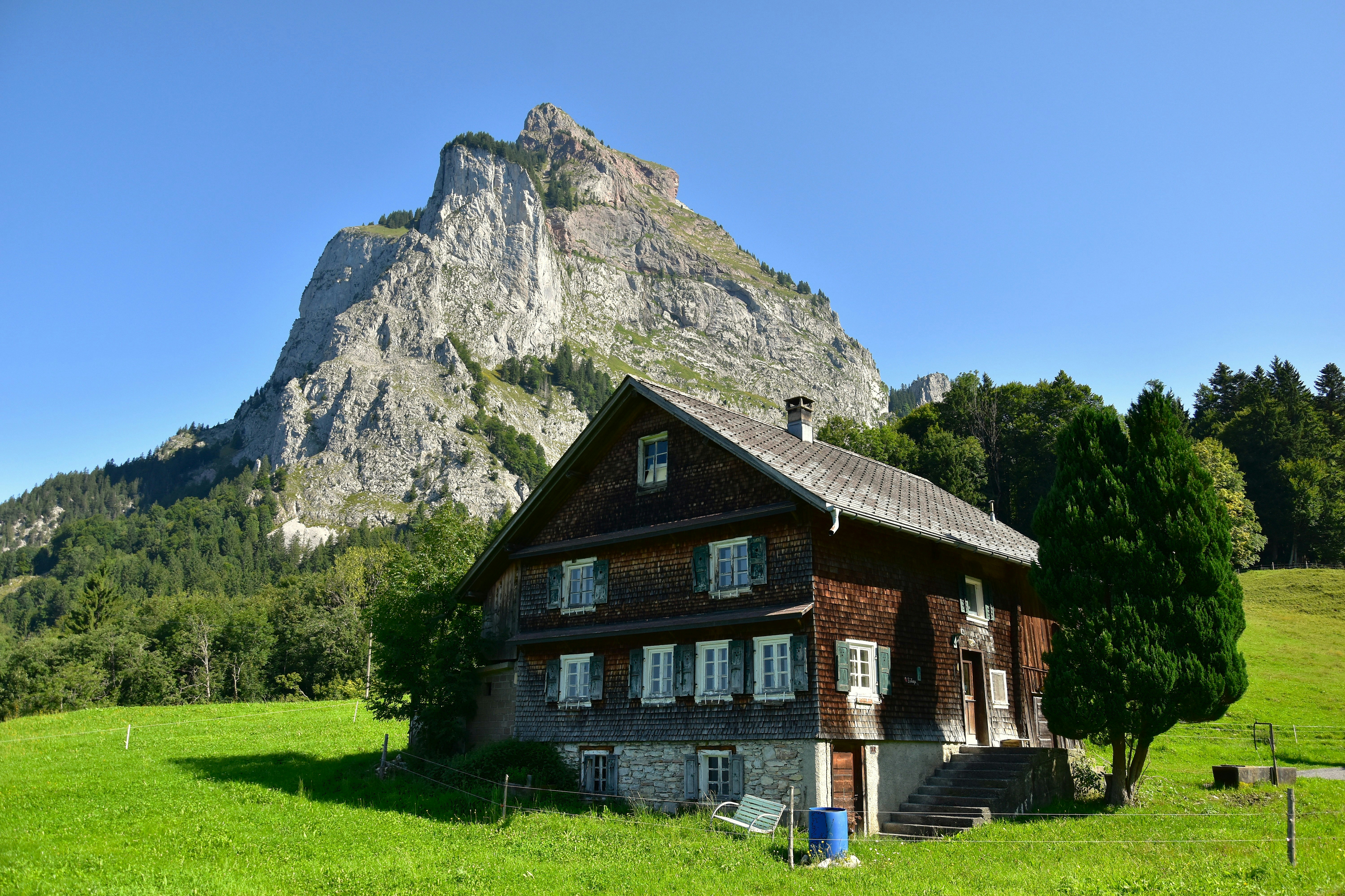 Wooden house in front of a large mountain