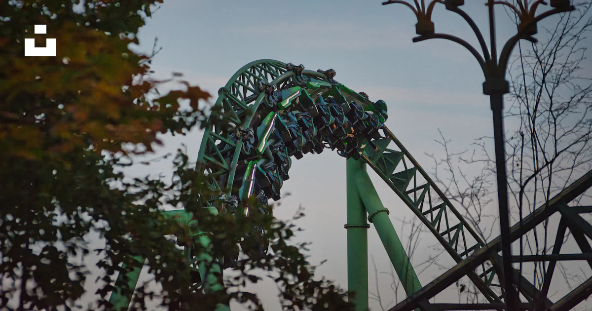 Roller coaster going down a steep drop at night photo – Free Adventure ...