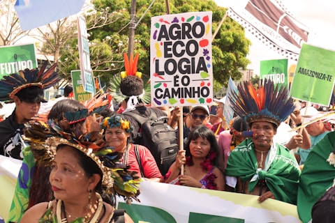 Indigenous people in traditional headdresses at a rally.