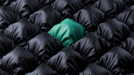 A single green fabric stands out from black