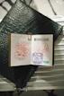 Open passport with colorful stamps and travel accessories.