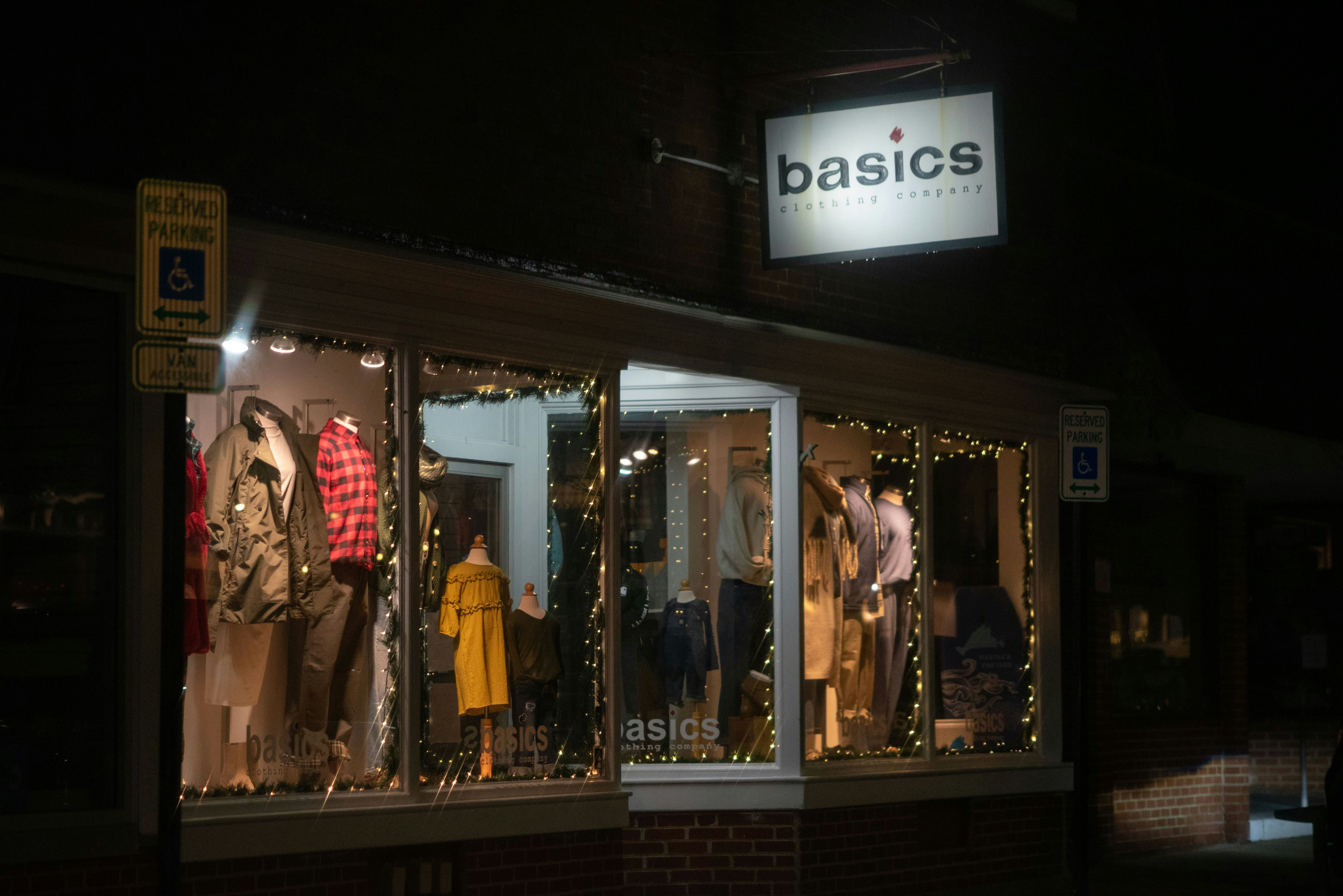Storefront window display at night with mannequins