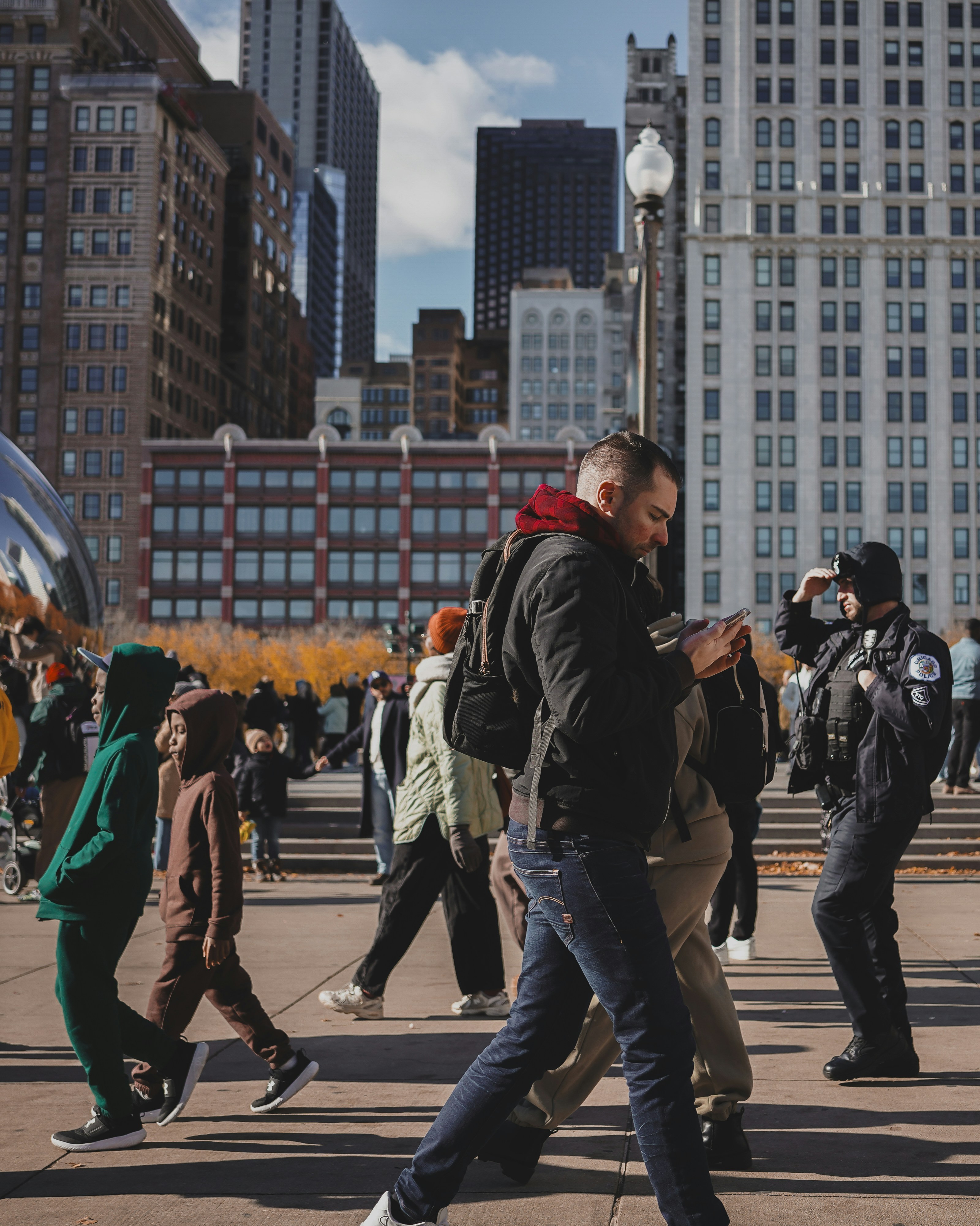 People walking on a city street with buildings in background