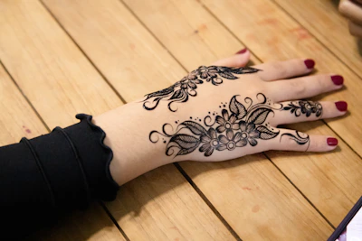 Intricate floral henna design on a hand