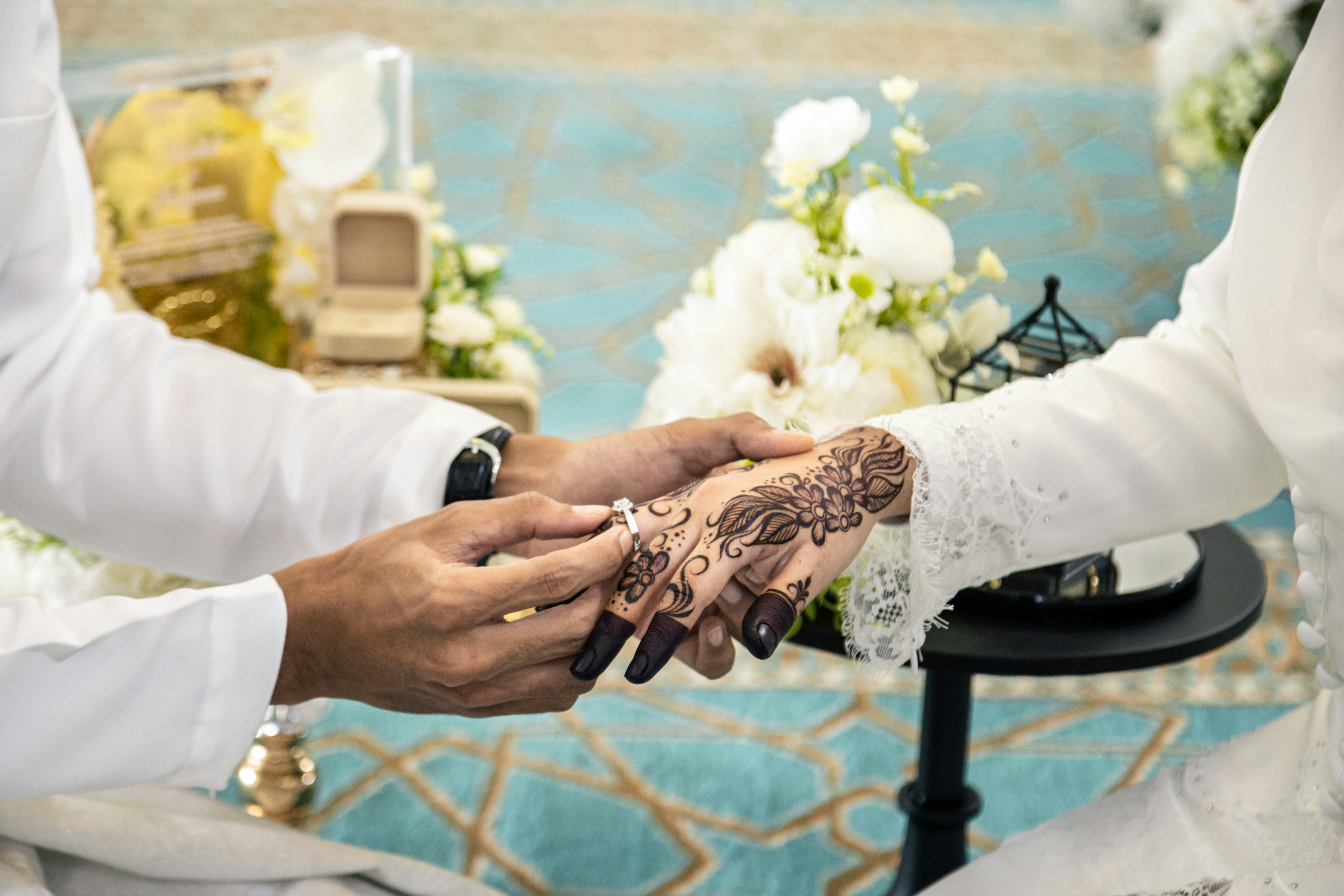 Groom places ring on bride's finger during wedding ceremony
