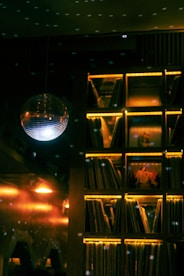Disco ball and illuminated record shelf at night