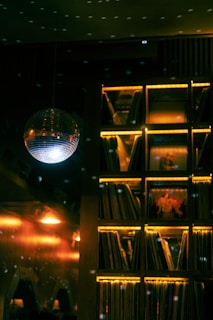Disco ball and illuminated record shelf at night