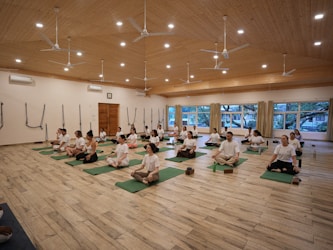 Group of people meditating in a yoga studio.