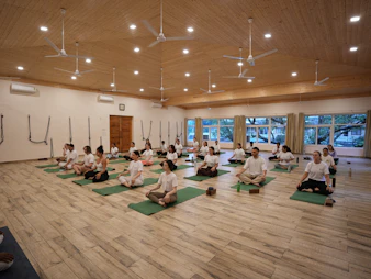 Group of people meditating in a yoga studio.