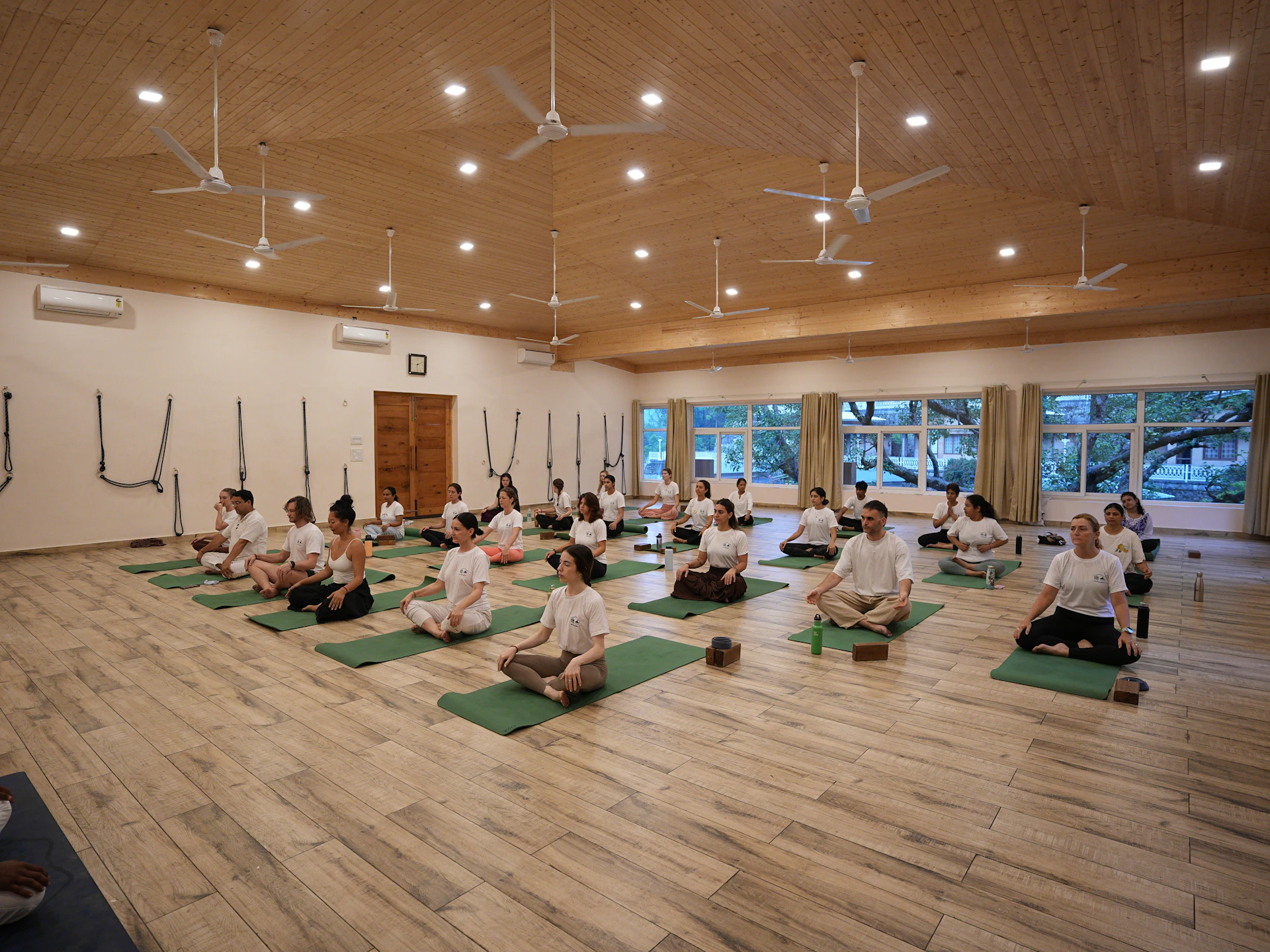 Group of people meditating in a yoga studio.
