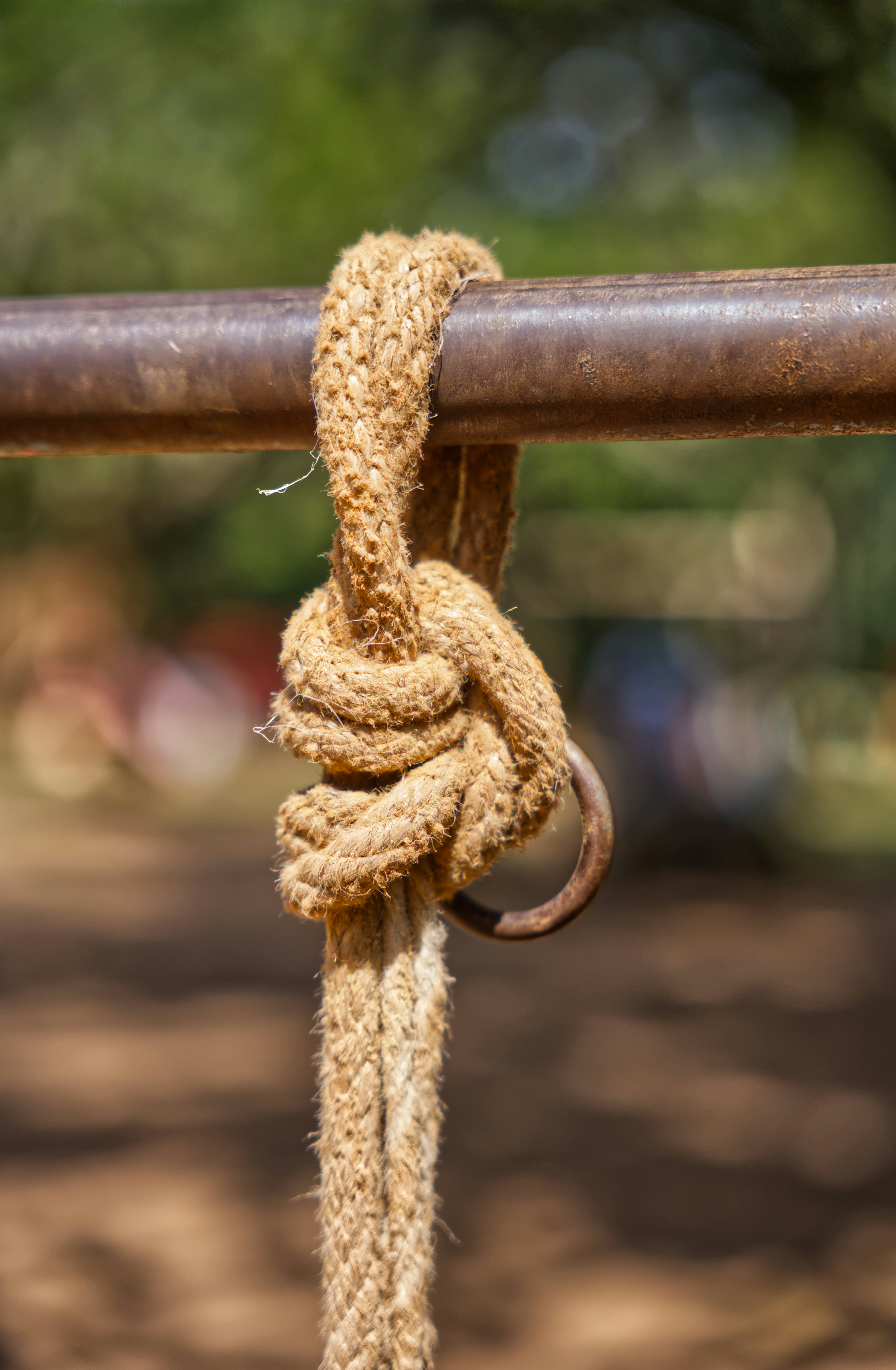 Thick rope tied with a knot on metal bar