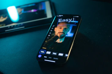 Smartphone displaying a man's face with "easy!" text.