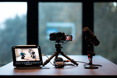 Camera, monitor, and microphone setup for recording.