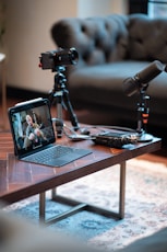 Podcast recording setup with camera, microphones, and tablet.