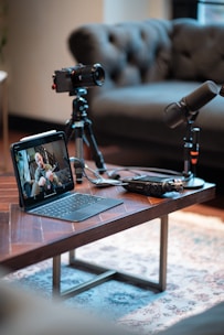 Podcast recording setup with camera, microphones, and tablet.