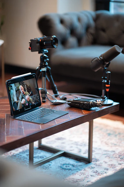 Podcast recording setup with camera, microphones, and tablet