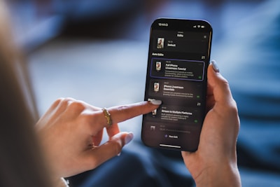 Person using a smartphone with a list on the screen