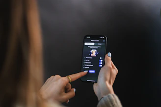 Woman's hand holding and touching smartphone screen of a smartphone