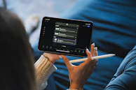 Person holding a tablet and stylus device.