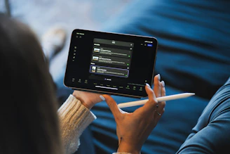 Person holding a tablet and stylus device.