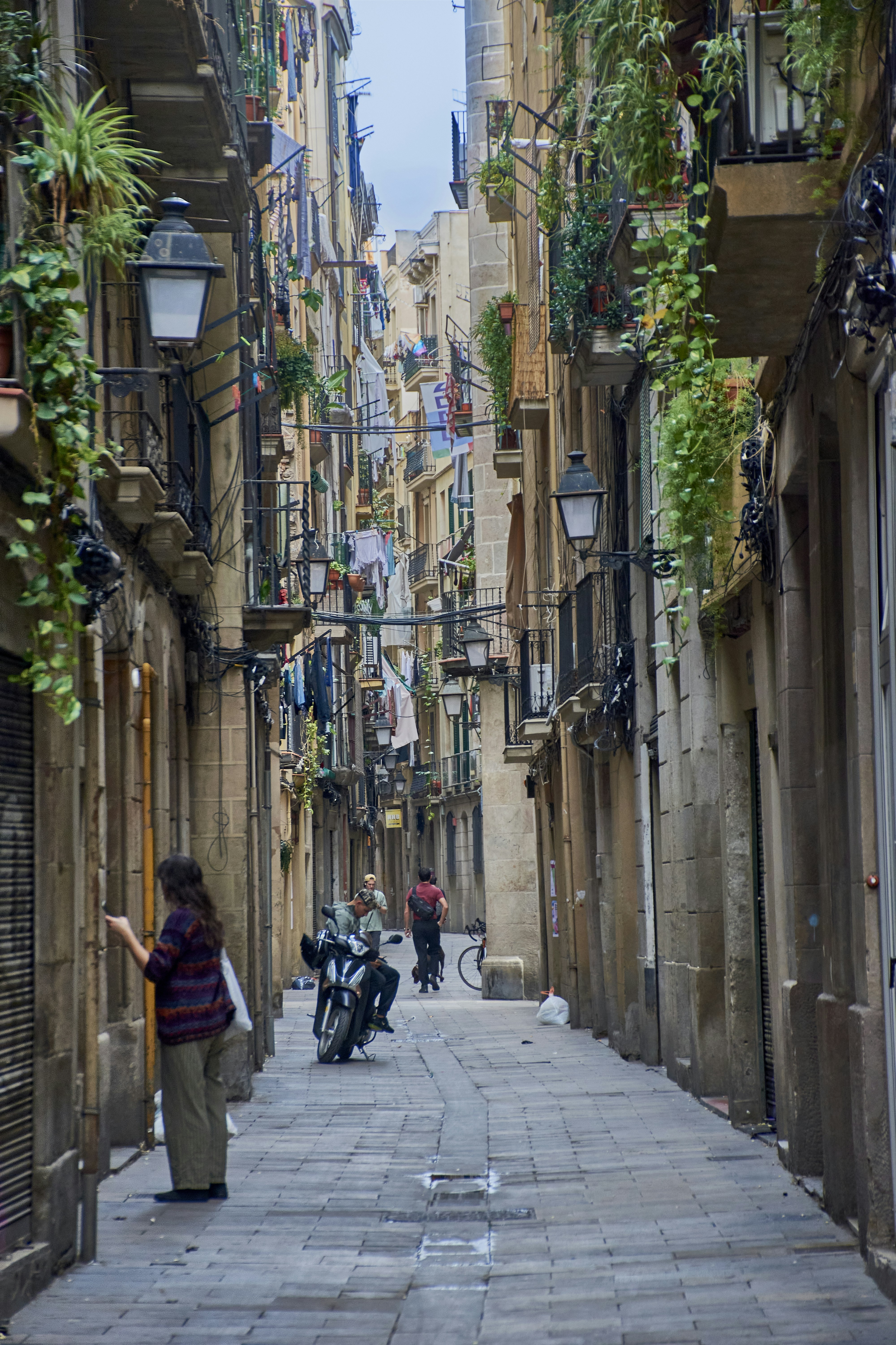 Narrow european street with buildings and people.