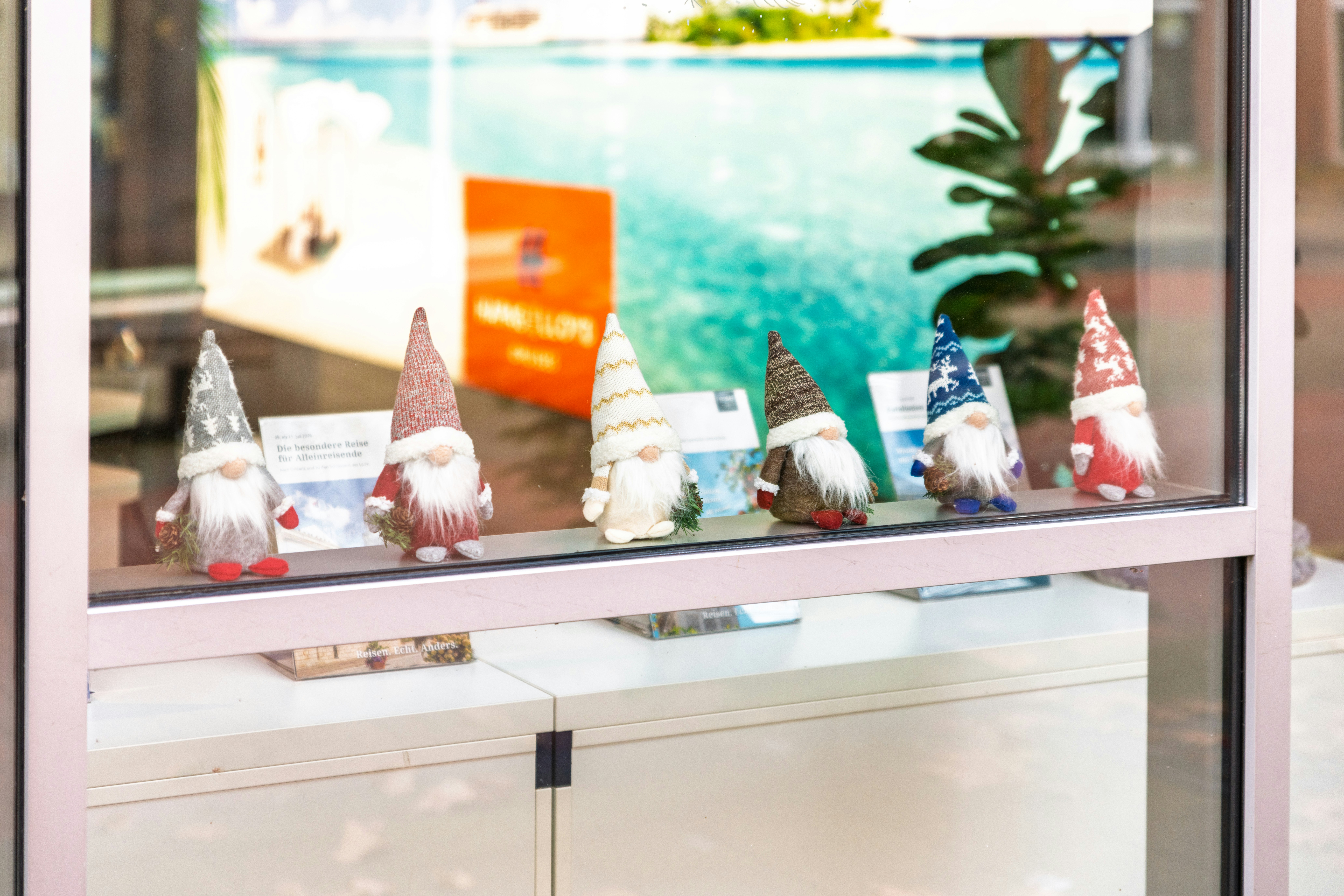 Several decorative gnomes displayed on a shelf.