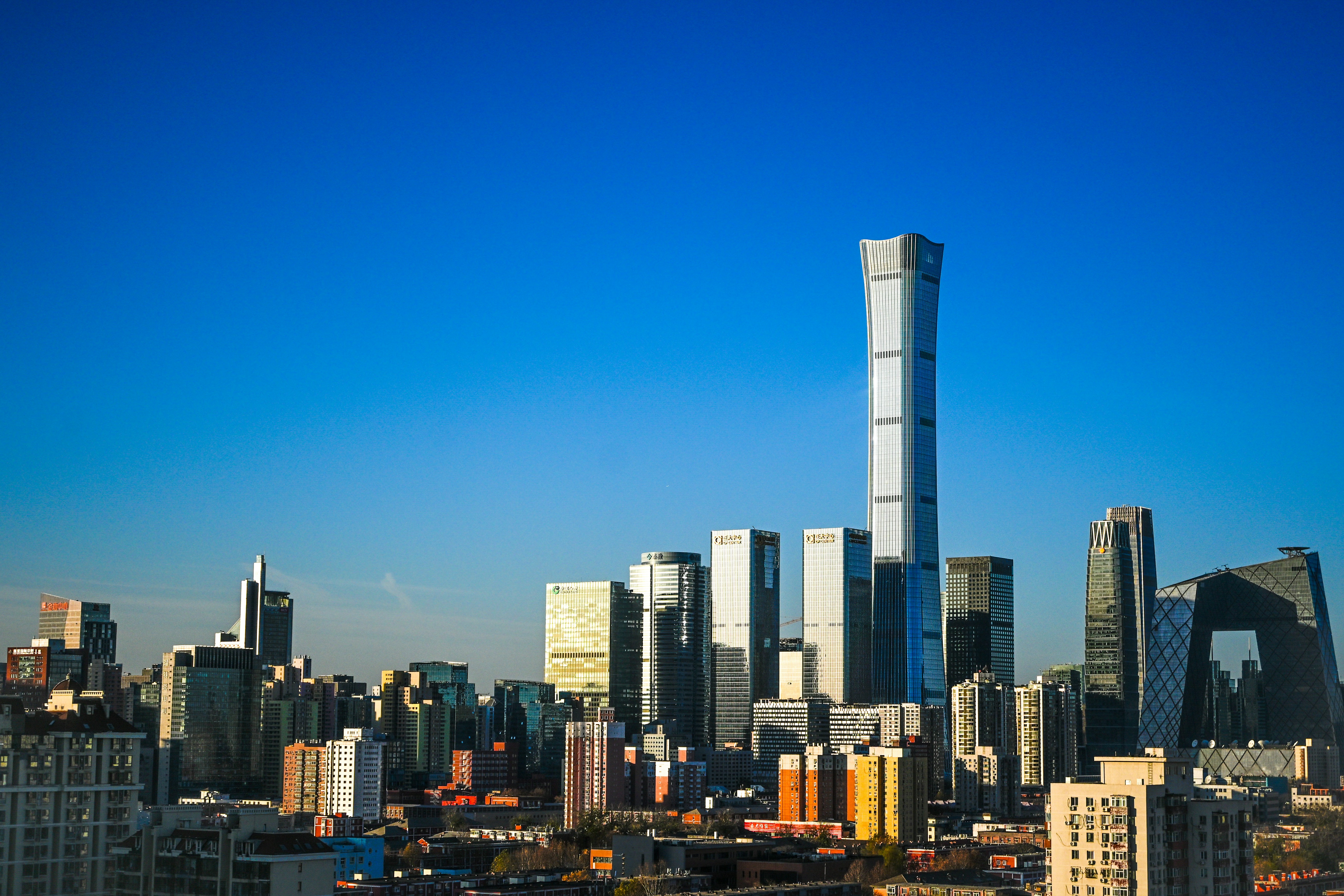 Modern cityscape with tall skyscrapers under a clear blue sky