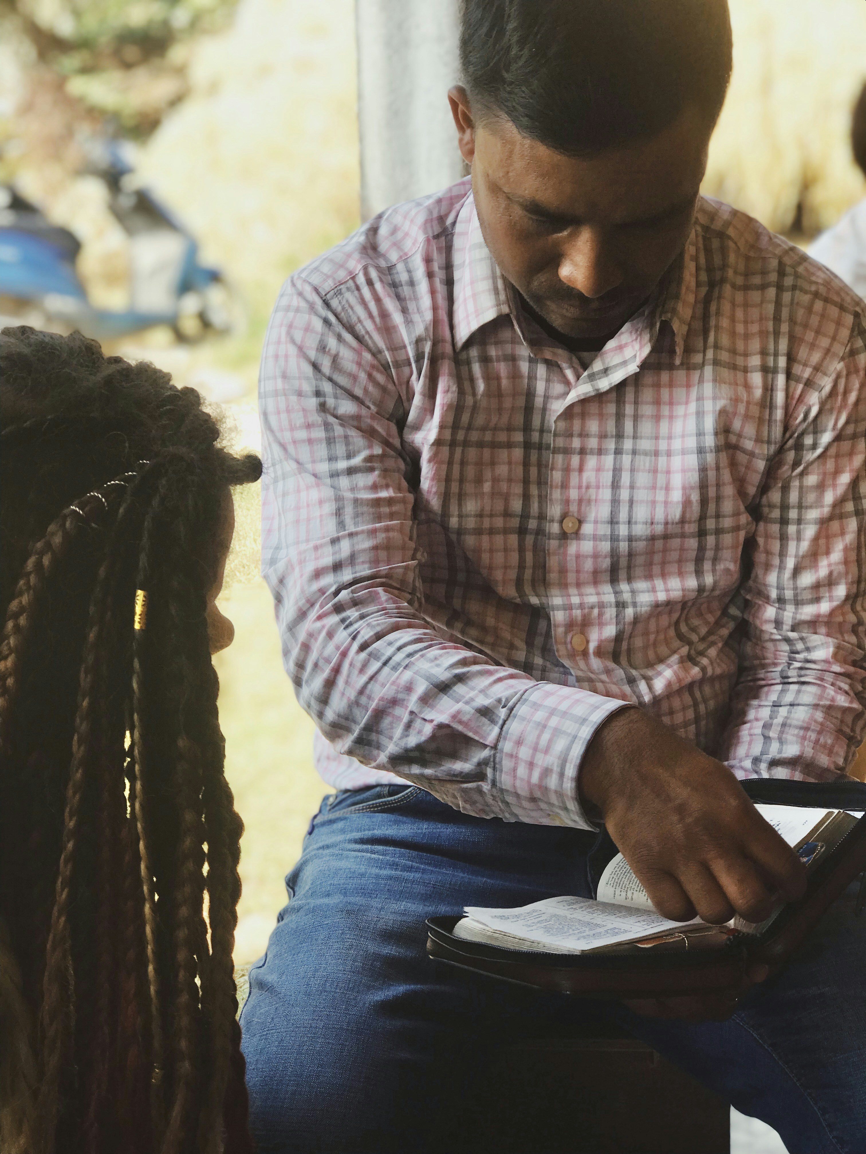 Man and child reading a book together.