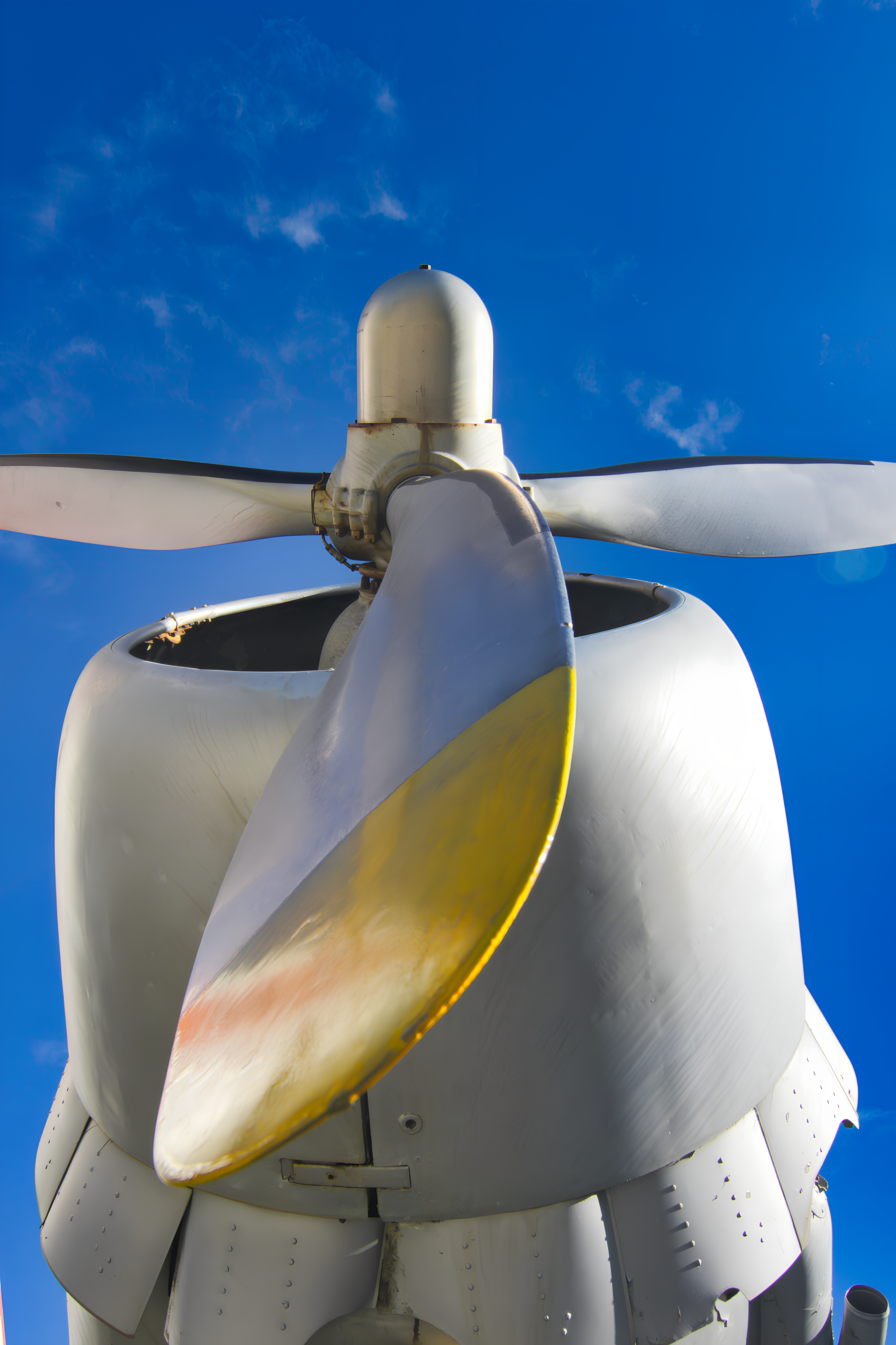 Airplane engine and propeller against blue sky