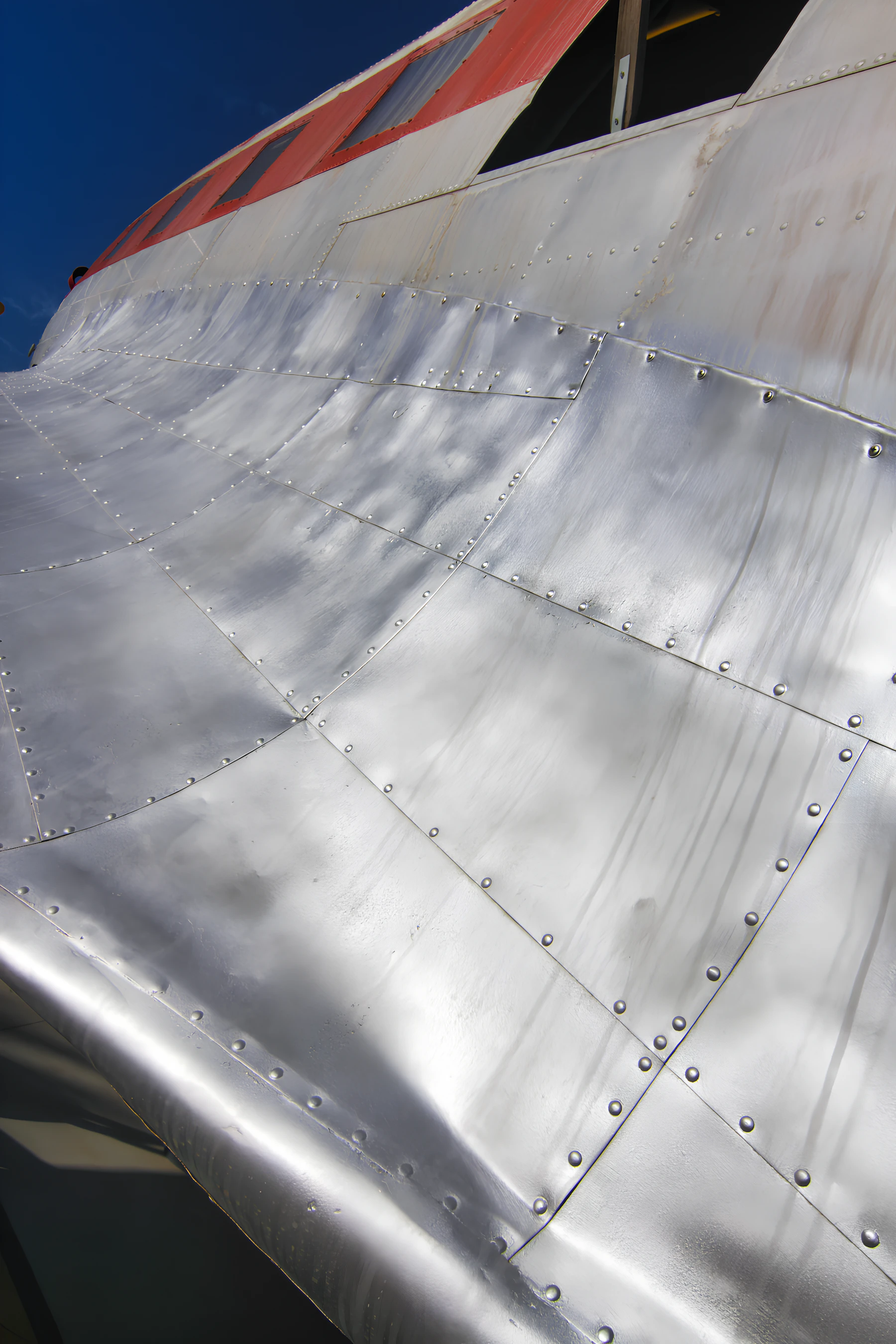 Close-up of a riveted aluminum aircraft fuselage