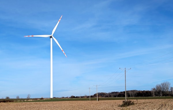 Wind turbine standing in an open field