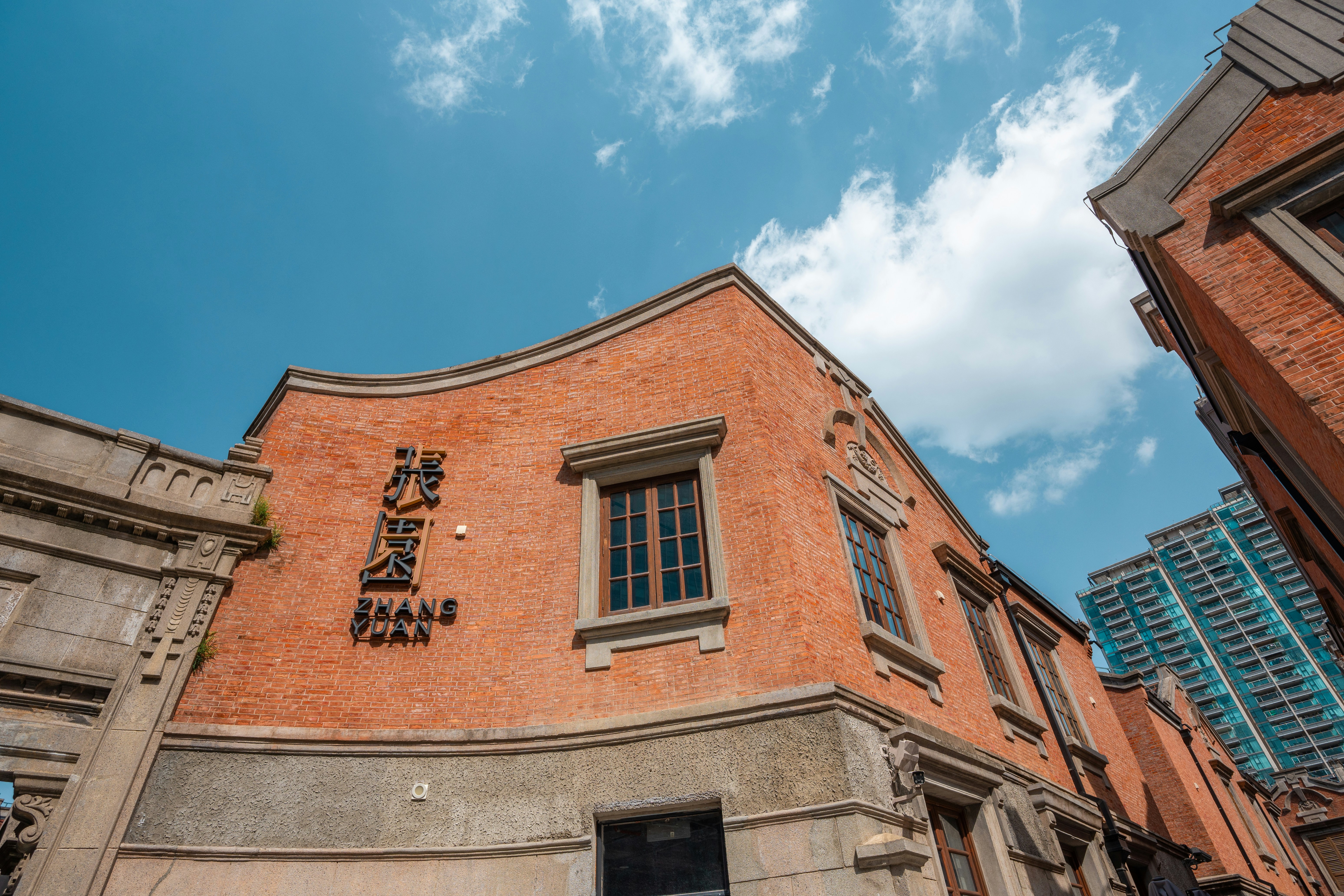 Orange brick building with windows under blue sky